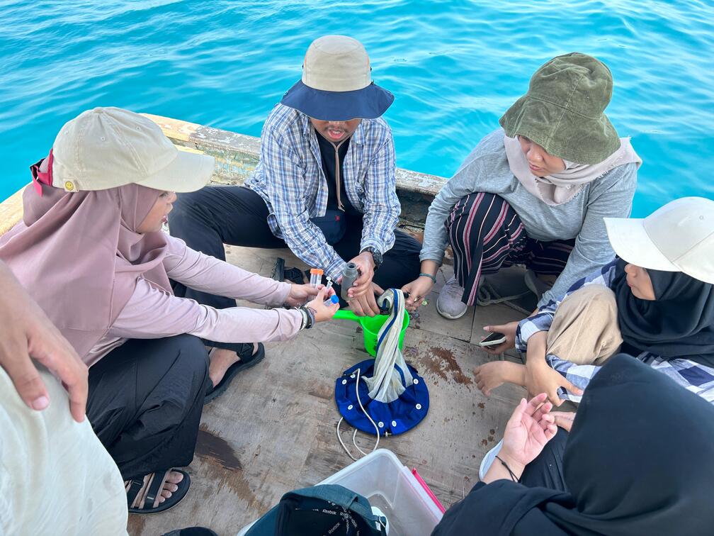 Gambar Tim KKN Abmas sedang mengambil air laut untuk pengukuran kadar limbah di laut