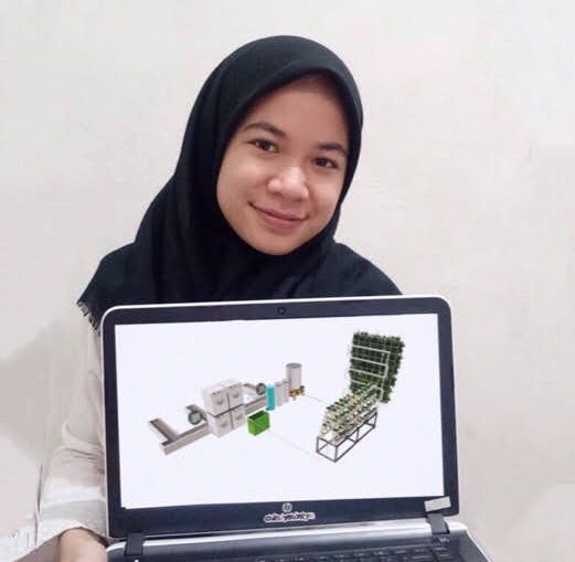 The Abdi Karya team leader, Cindy Synthia Putri, showing the initial design of wastewater treatment plant for small scale laundry business.