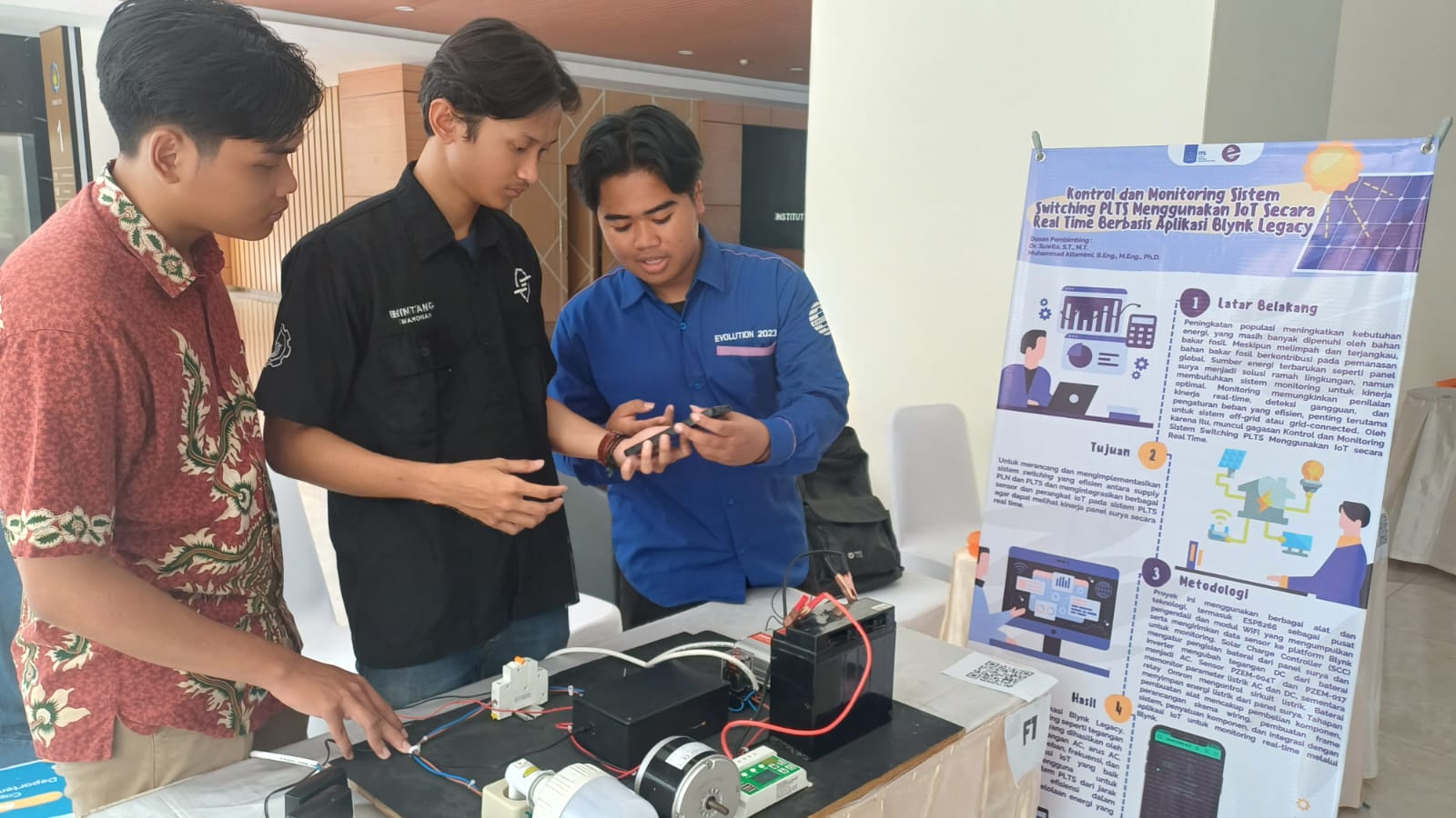 Foto Mahasiswa kelompok F1 Departemen Teknik Elektro menjelaskan inovasinya tentang sistem monitoring PLTS 