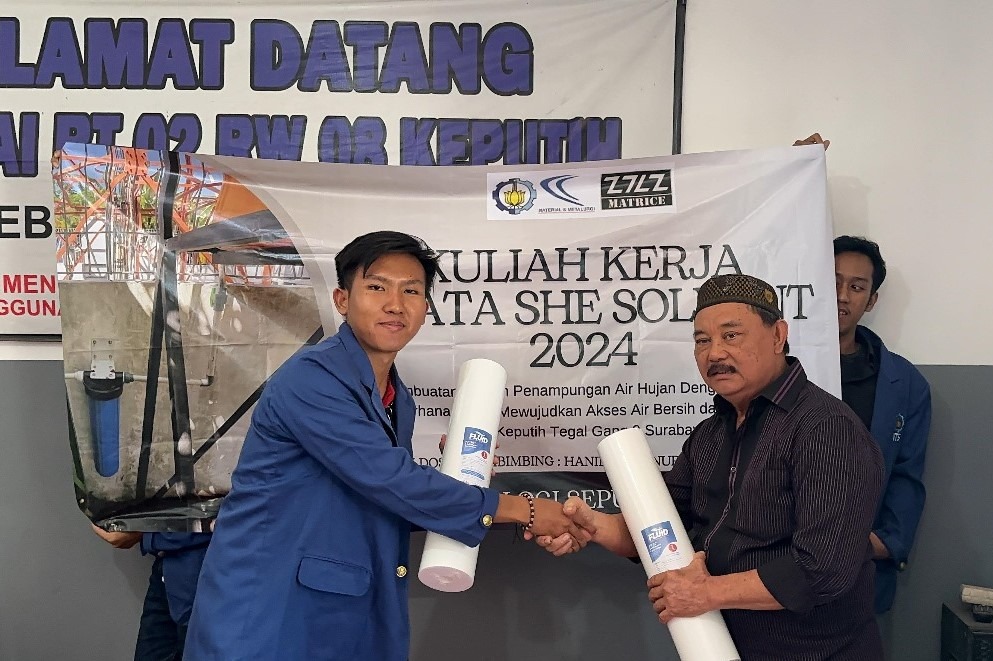 Ketua tim KKN Departemen Teknik Material Metalurgi (DTMM) ITS Naufal Rafi Zharfandy (kiri) saat penyerahan catridge filter air kepada Ketua RT 02 RW 08 Keputih Patnowo Hadi Supatmono (kanan)