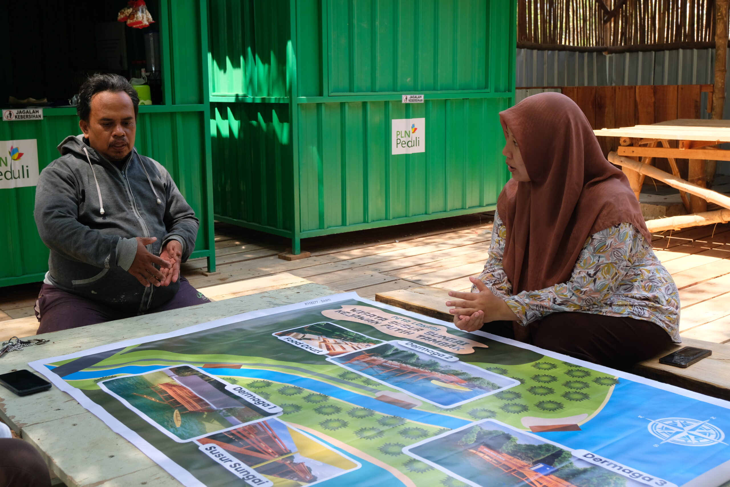 Gambar Santi ketika berdiskusi dengan petugas wisata Susur Sungai Kejawan Putih Tambak